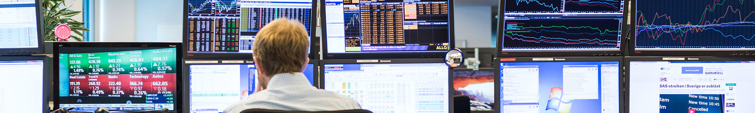 Man in front of monitors