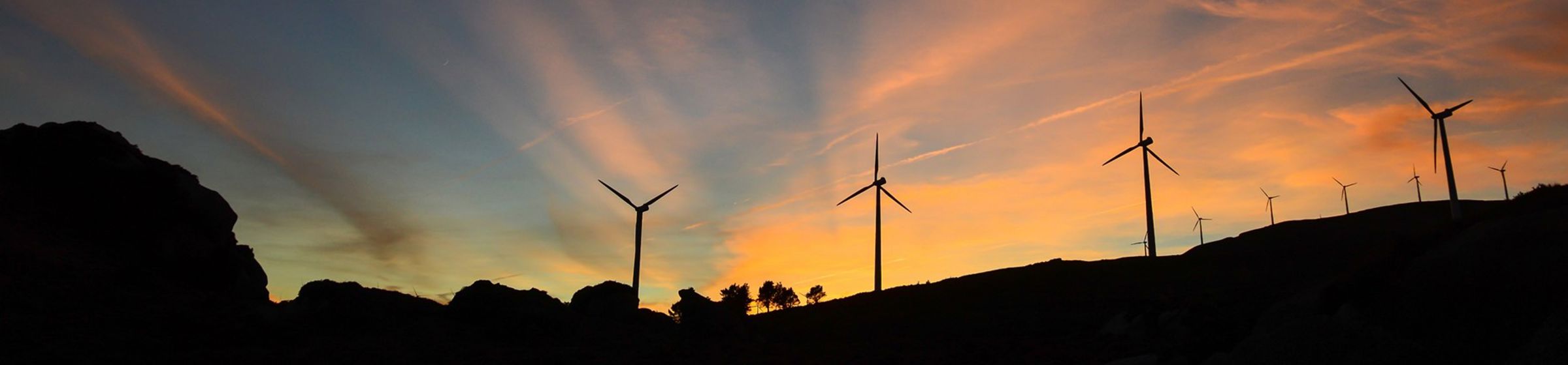 A sunrise behind a wind park